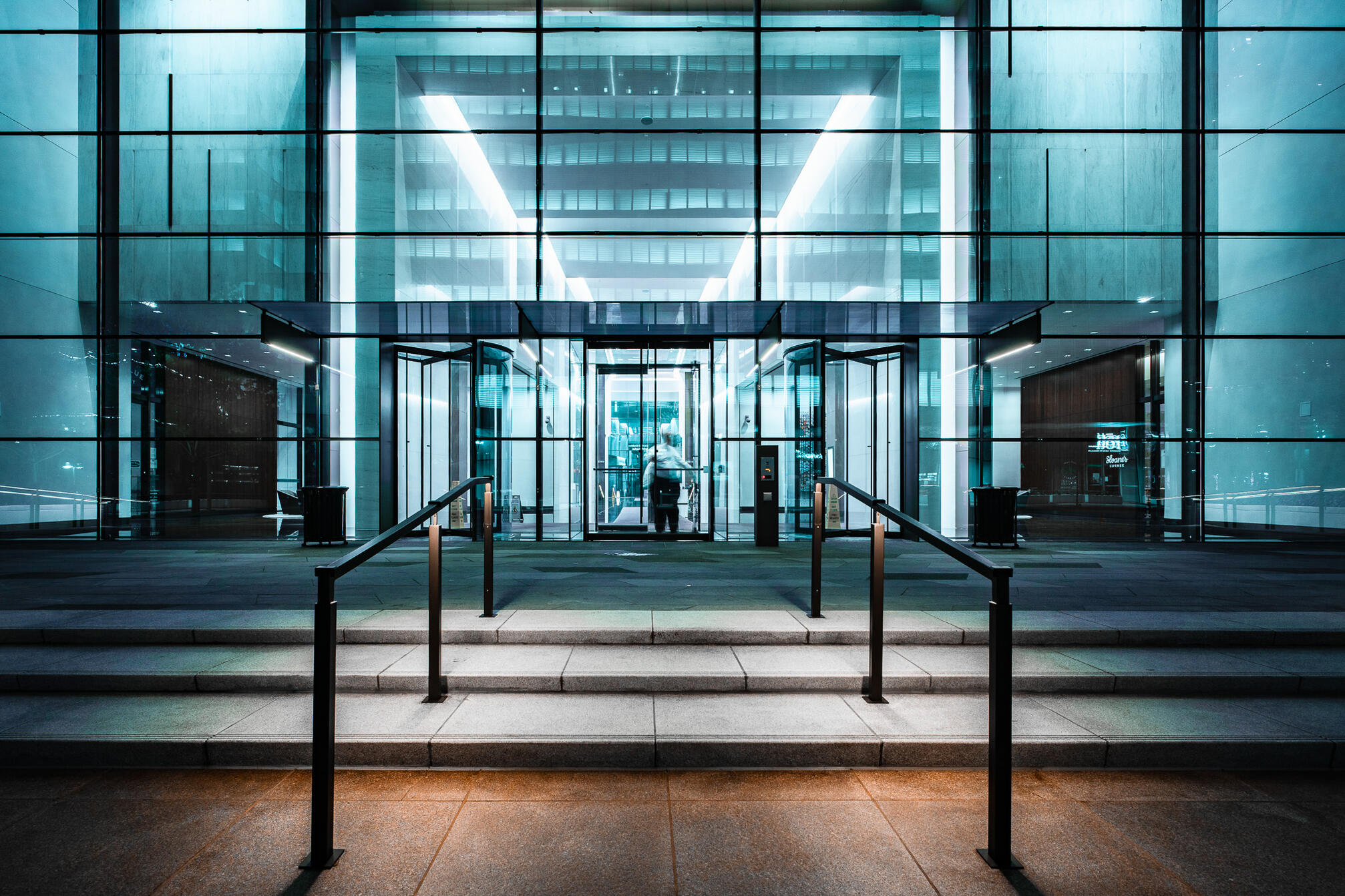 Downtown Dallas steel and glass building lobby at night.